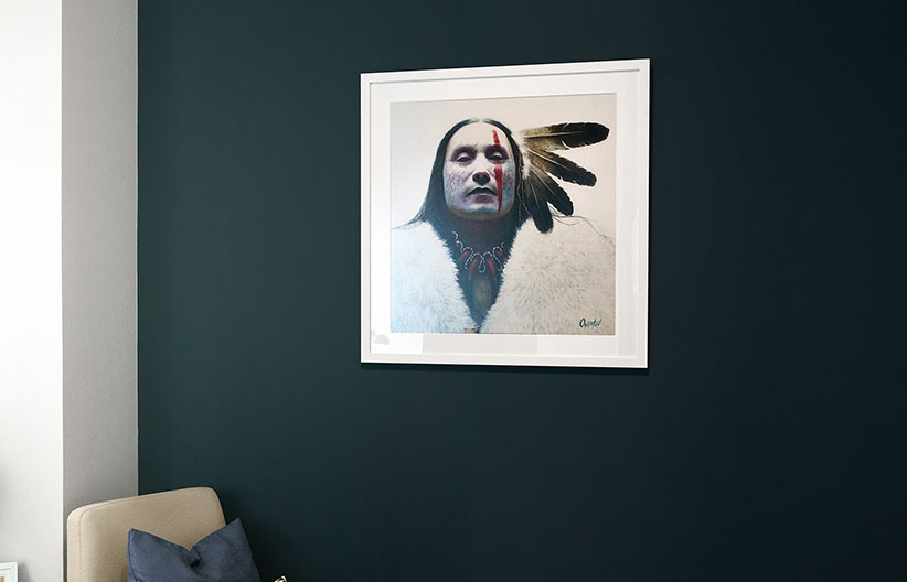 Native American print on a dark blue wall